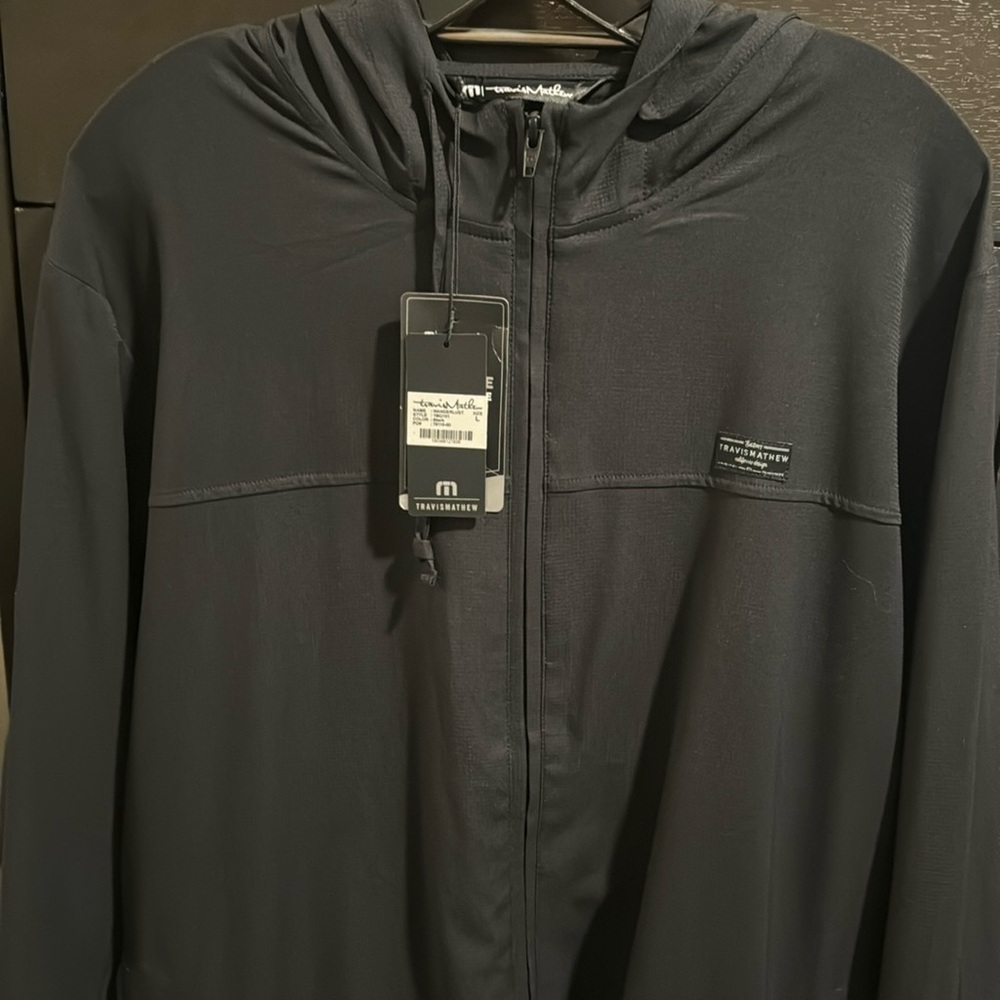 Travis Mathew Zip up hoodie w Tito’s logo.